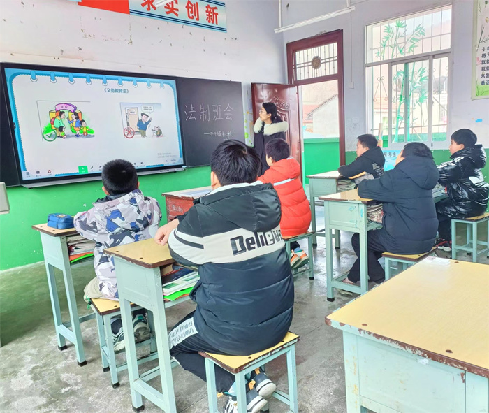 高年级法治班会课上组织学生学习《义务教育法》.jpg 高年级法治班会课上组织学生学习《义务教育法》.jpg